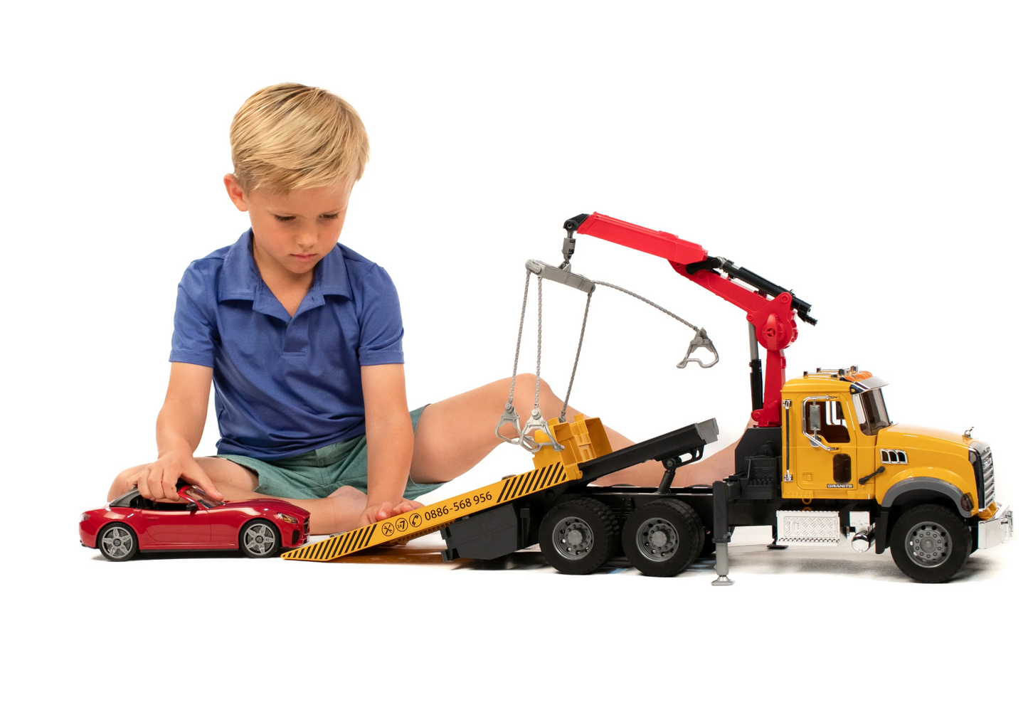 MACK Granite Tow Truck with BRUDER Roadster